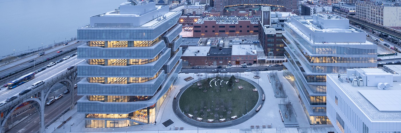 Aerial view both both Columbia Business School buildings and the Square, with the Riverside Dr viaduct on the left.