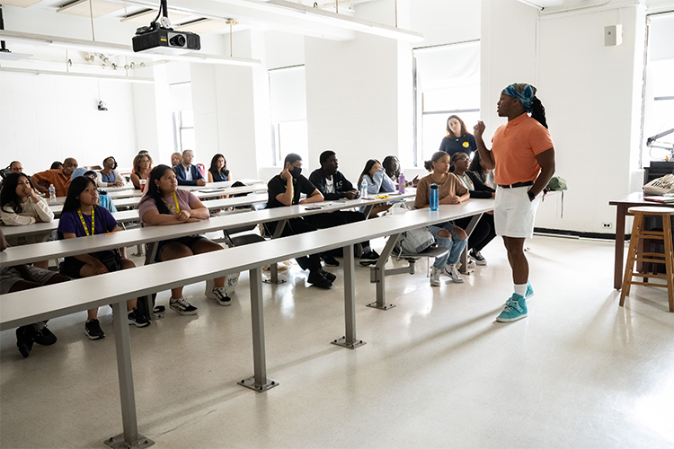 Sociology Instructor Jay Brown addresses a class of Double Discovery Center students, local elected officials, and Columbia President Minouche Shafik. 