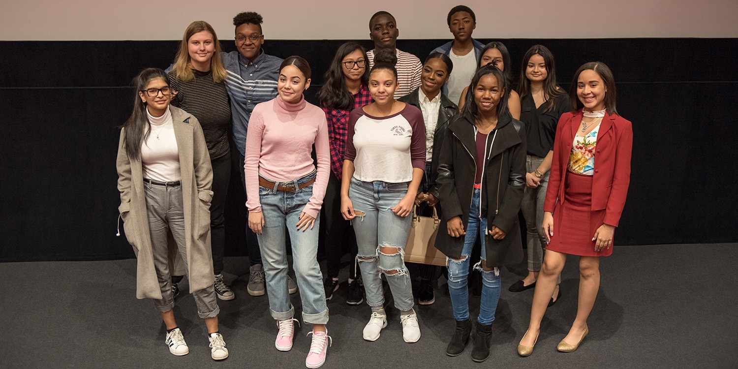 Students standing together in front of screen. Photo Credit: Emily Skillings, SOA ’17