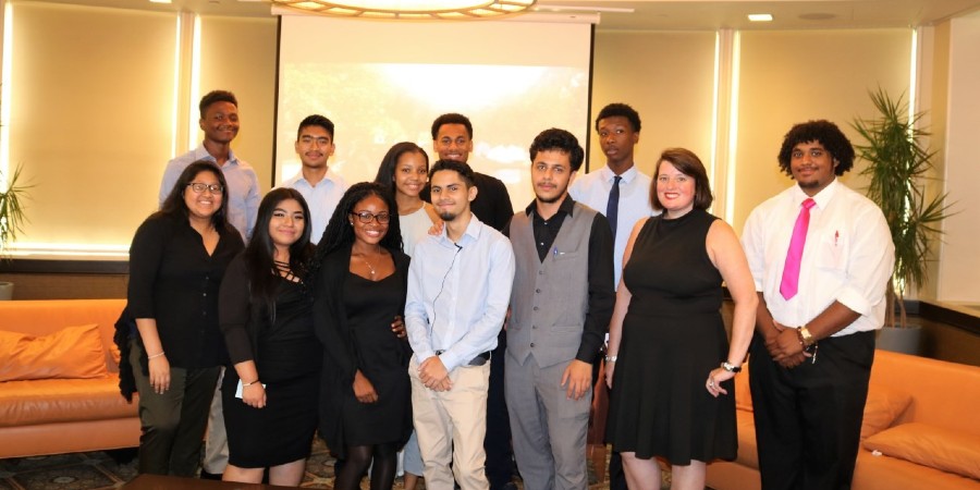 A group of 12 young men and women in two rows, wearing business attire. They were the 2018 CUFO high school interns.