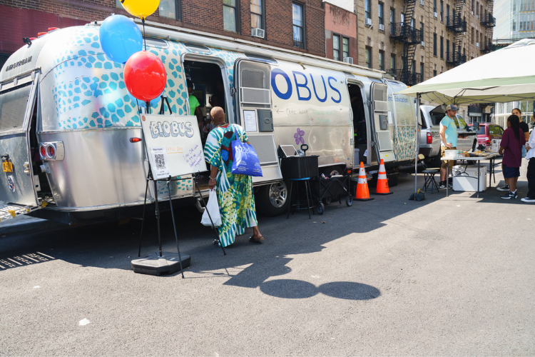  Attendees at the back-to-school event check out Columbia University Zuckerman Institute’s BioBus—a retrofitted Airstream trailer that serves as a science lab on wheels. Photo Credit: Henry Danner