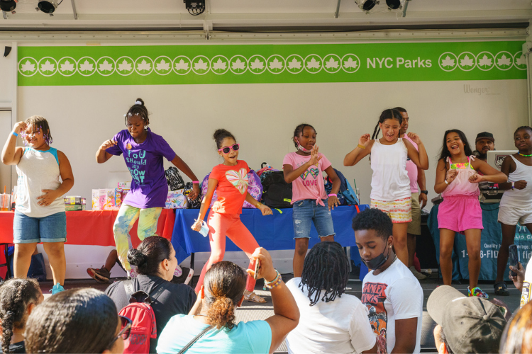 A group of girls participate in a dance competition during the back-to-school event in West Harlem. Photo Credit: Henry Danner