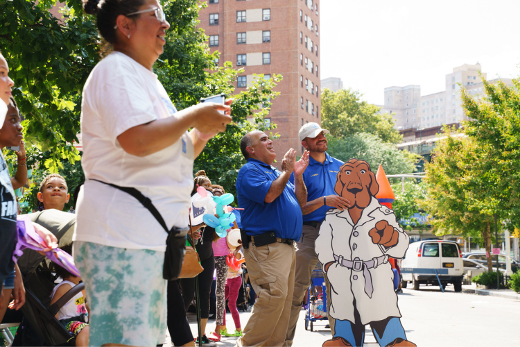 Public Safety officers Ricardo Morales and Amin Torres enjoying a dance competition at the West Harlem back-to-school event. Photo Credit: Henry Danner