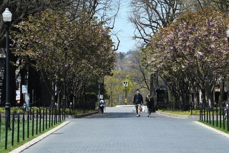 Looking west across Broadway from College Walk. People are walking onto campus wearing masks.