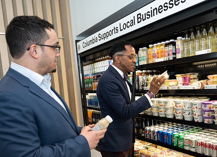 Council Member Shaun Abreu and Assembly Member Al Taylor inspect the local vendors on display in the Cafe on the ground floor of David Geffen Hall. 