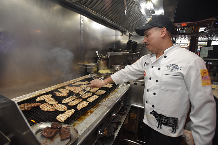 Chef cooking at Ricardo Steakhouse. 