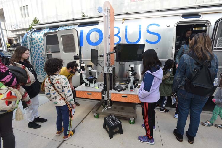 Attendees checkout science activities at the BioBus. 