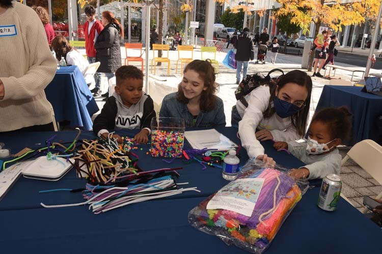 Participants work on Saturday Science activities in The Square in between Jerome L. Greene Science Center and Lenfest Center for the Arts. 