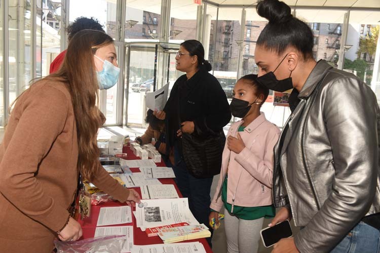 Representatives from George Bruce Library meet with attendees. 