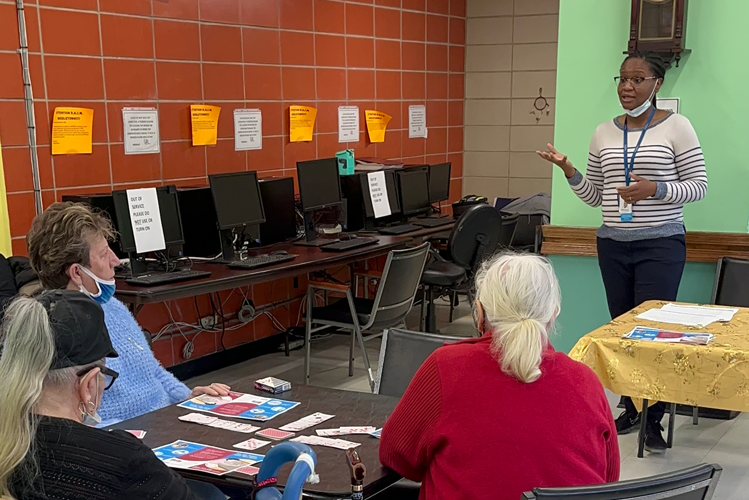 A woman teaches two women in a room.