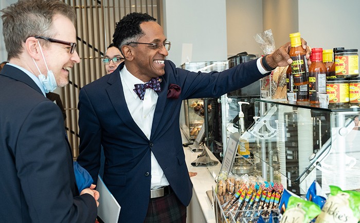 Assembly Member Al Taylor and Nathan Robb, Assistant Vice President for Government Relations in Columbia's Office of Government and Community Affairs, inspect Vy Higgensen's Mama's One Sauce, one of the local items on sale in Geffen Hall's ground floor cafe, which is open to the public. Photo by Diane Bondareff. Assembly Member Al Taylor and Nathan Robb, Assistant Vice President for Government Relations in Columbia's Office of Government and Community Affairs, inspect Virginia Higginbotham's Mama's One Sauce, one of the local vendors on sale in Geffen Hall's ground floor cafe, open to the community. Photo by Diane Bondareff.