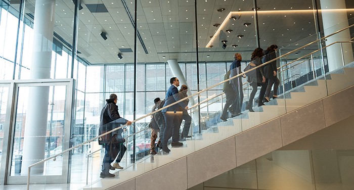 Elected and community leaders make their way up the lobby staircase in David Geffen Hall to the Columbia-Harlem SBDC offices. Photo by Diane Bondareff. The lobby staircase in David Geffen Hall with elected and community leaders on it.