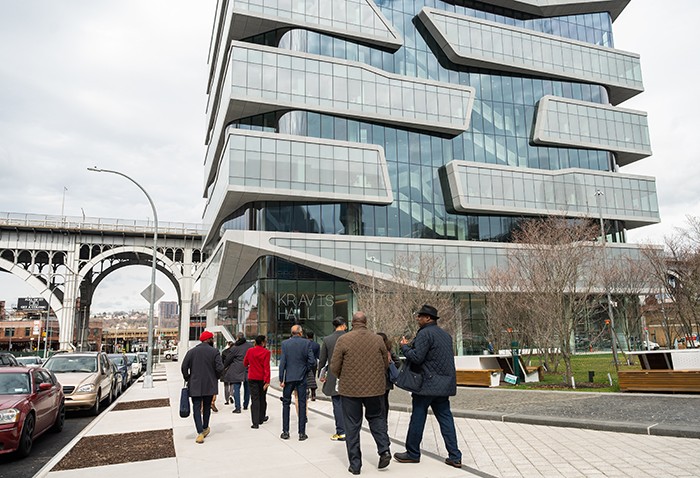 Tour attendees walk past The Square, the largest public park on any of Columbia’s campuses, which sits between the Henry Kravis and David Geffen buildings. Photo by Diane Bondareff. Tour leaders walk to Kravis Hall, past the Circle.