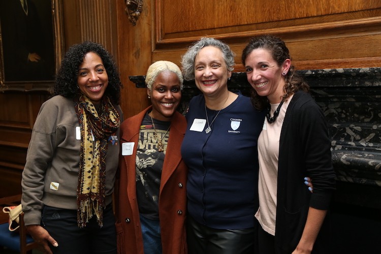 The 10th cohort of Bundles Scholars at their welcome reception. Photo by Bruce Gilbert. Four women smiling at the camera.