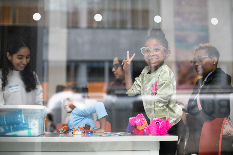 Saturday Science participants wave a peace sign during Manhattanville Community Day in October 2023. 