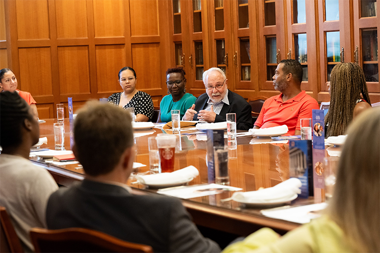 After the classroom visit, DDC Founder Roger Lehecka speaks at a luncheon with community leaders, including DDC Executive Director Sasha Wells and DDC Board of Friends Chair Natalie Edwards. Photo by Diane Bondareff/Columbia University. Double Discovery Center Founder Roger Lehecka speaks to a table of community leaders.