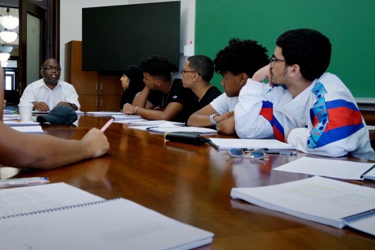 Students at a table in a classroom.