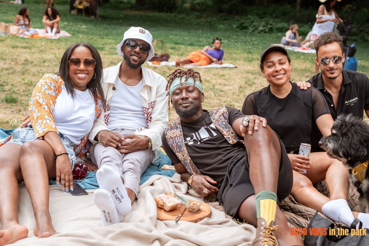 Group of friends post for a photo during Good Vibes in the Park, a summer event in St. Nicholas Park