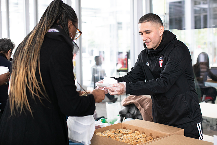 A variety of local businesses that work with Columbia University Small Business Development Center brought tasty treats to Community Day. Photo by David Dini. A local vendor shares cookies at Community Day