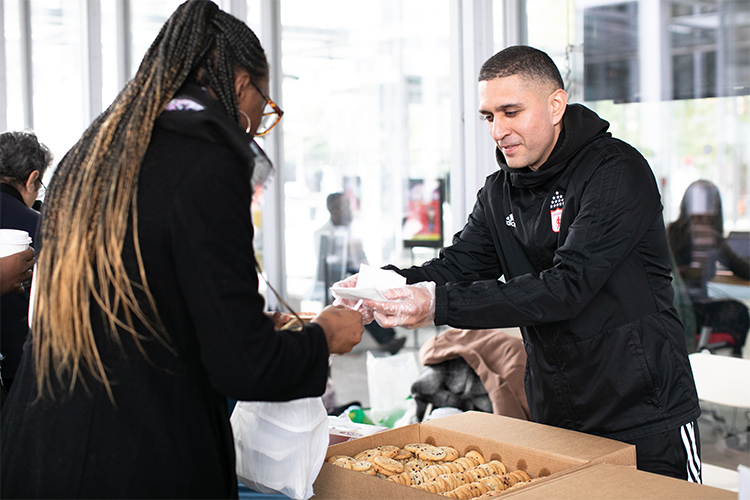 A local vendor shares cookies at Community Day