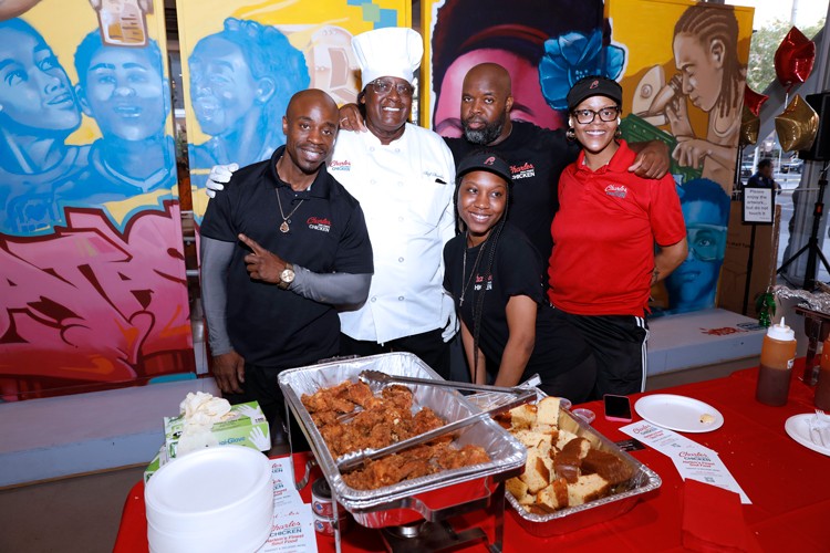 A chef and his cooking crew pose for a photo during Taste of Harlem, an event that took place at The Forum in 2023. 