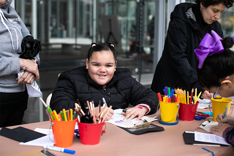 A happy participants draws outside. 