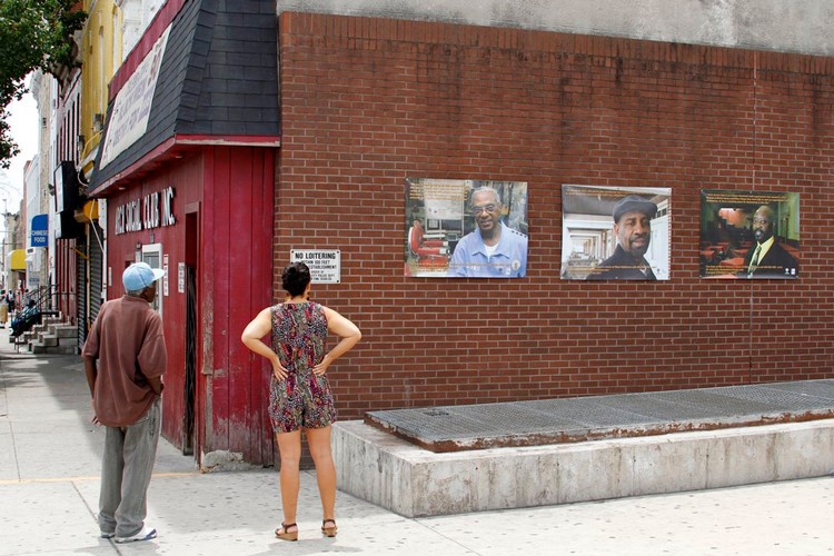 People viewing photography by Bayeté Ross Smith in Baltimore.