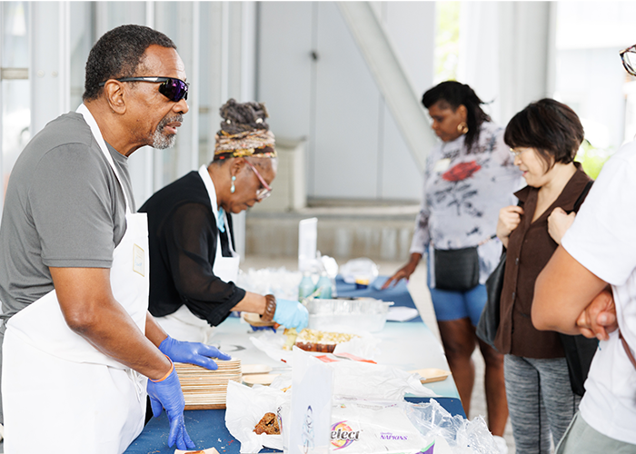 Columbia University Small Business Development Center partner Chatman J. Cakes hands out delicious samples at Manhattanville Community Day. Photo by Sirin Samman. vendors at community day