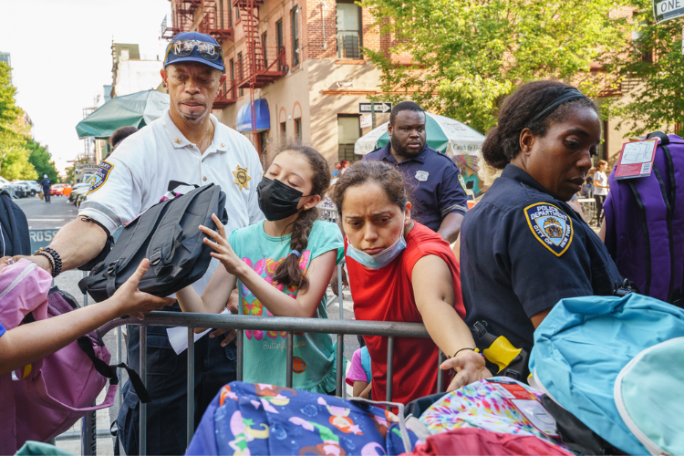Attendees at the back-to-school event receive backpacks filled with school supplies. Photo Credit: Henry Danner Attendees at the back-to-school event receive backpacks filled with school supplies. Photo Credit: Henry Danner