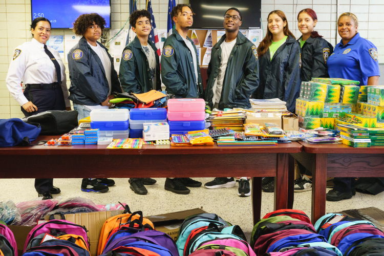 Deputy Inspector Alexandra Sarubbi, Detective Johanna Ureña and youth from the 26th Precincts NYPD Explorers program after a long day of unpacking and sorting supplies for the annual back-to-school event. Photo Credit: Henry Danner Deputy Inspector Alexandra Sarubbi, Detective Johanna Ureña and youth from the 26th Precincts NYPD Explorers program after a long day of unpacking and sorting supplies for the annual back-to-school event. Photo Credit: Henry Danner