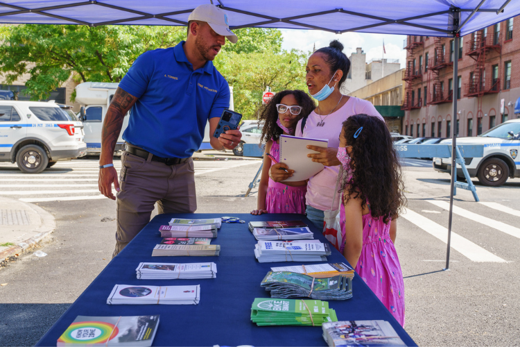 Public Safety Officer Amin Torres speaks to some community members during the annual back-to-school event in West Harlem. Torres works alongside Ricardo Morales who says that the Department of Public Safety and the 26th Precinct officers’ participation in community events helps community members to view law enforcement members as a valuable resource. Photo Credit: Henry Danner Public Safety Officer Amin Torres speaks to some community members during the annual back-to-school event in West Harlem. Torres works alongside Ricardo Morales who says that the Department of Public Safety and the 26th Precinct officers’ participation in community events helps community members to view law enforcement members as a valuable resource. Photo Credit: Henry Danner