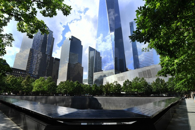 The 9/11 Memorial in the foreground with skyscrapers visible behind it.