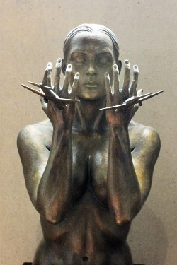 September 11th: A Memorial for the Cathedral of St. John the Divine. Photo by Guido Verona. A sculpture of a woman with her hands up as planes fly into them.