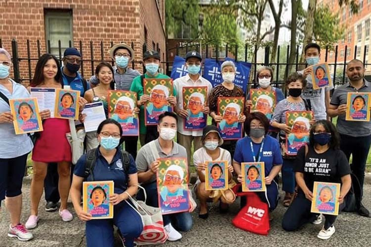 Upper Manhattan Asian Alliance members gather for their first event, canvassing East Harlem to raise awareness about the need to protect the neighborhood's Asian population. People with masks on holding images of art