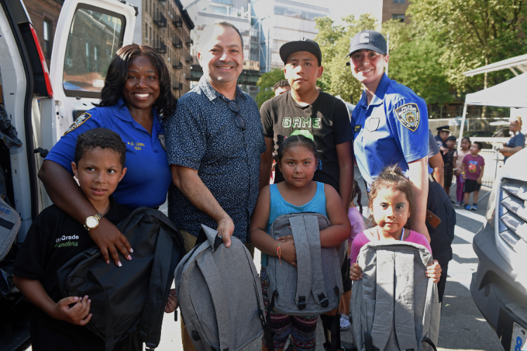 Attendees take a photo with West Harlem Development Corporation Executive Director Zead Ramadan, NYPD Community Affairs Officer Anna Cardenas, and another member of the NYPD Community Affairs team. Photo credit: Susan Farley. Attendees take a photo with West Harlem Development Corporation Executive Director Zead Ramadan, NYPD Community Affairs Officer Anna Cardenas, and another member of the NYPD Community Affairs team. Photo credit: Susan Farley