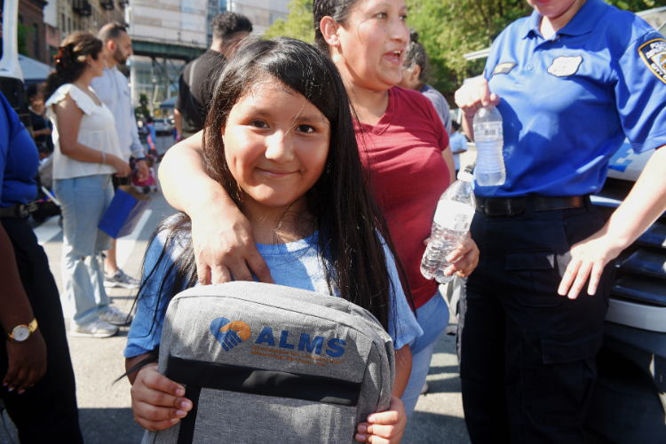 A youngster poses with her new backpack at the annual back-to-school event in West Harlem. Photo credit: Susan Farley A youngster poses with her new backpack at the annual back-to-school event in West Harlem. Photo credit: Susan Farley