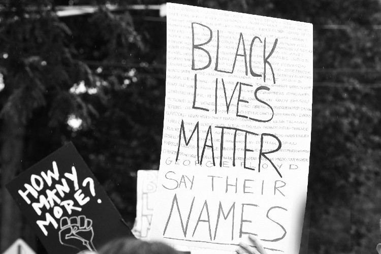 Poster with words black lives matter and how many more. 