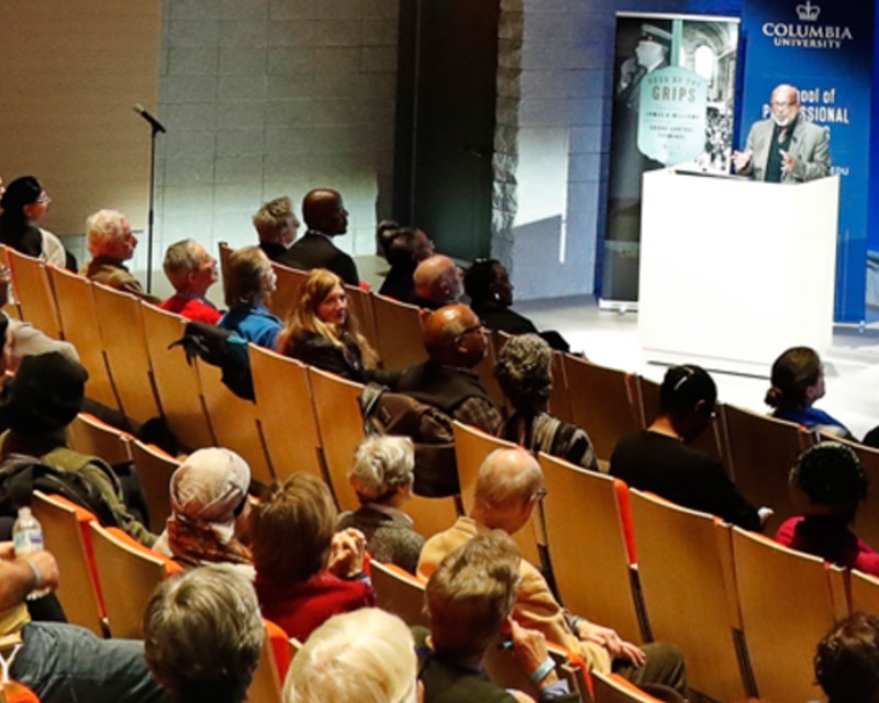 Eric K. Washington speaks to guests in auditorium 