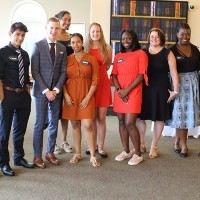 A group of young adults in businesswear.