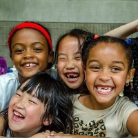 Four young girls laughing.