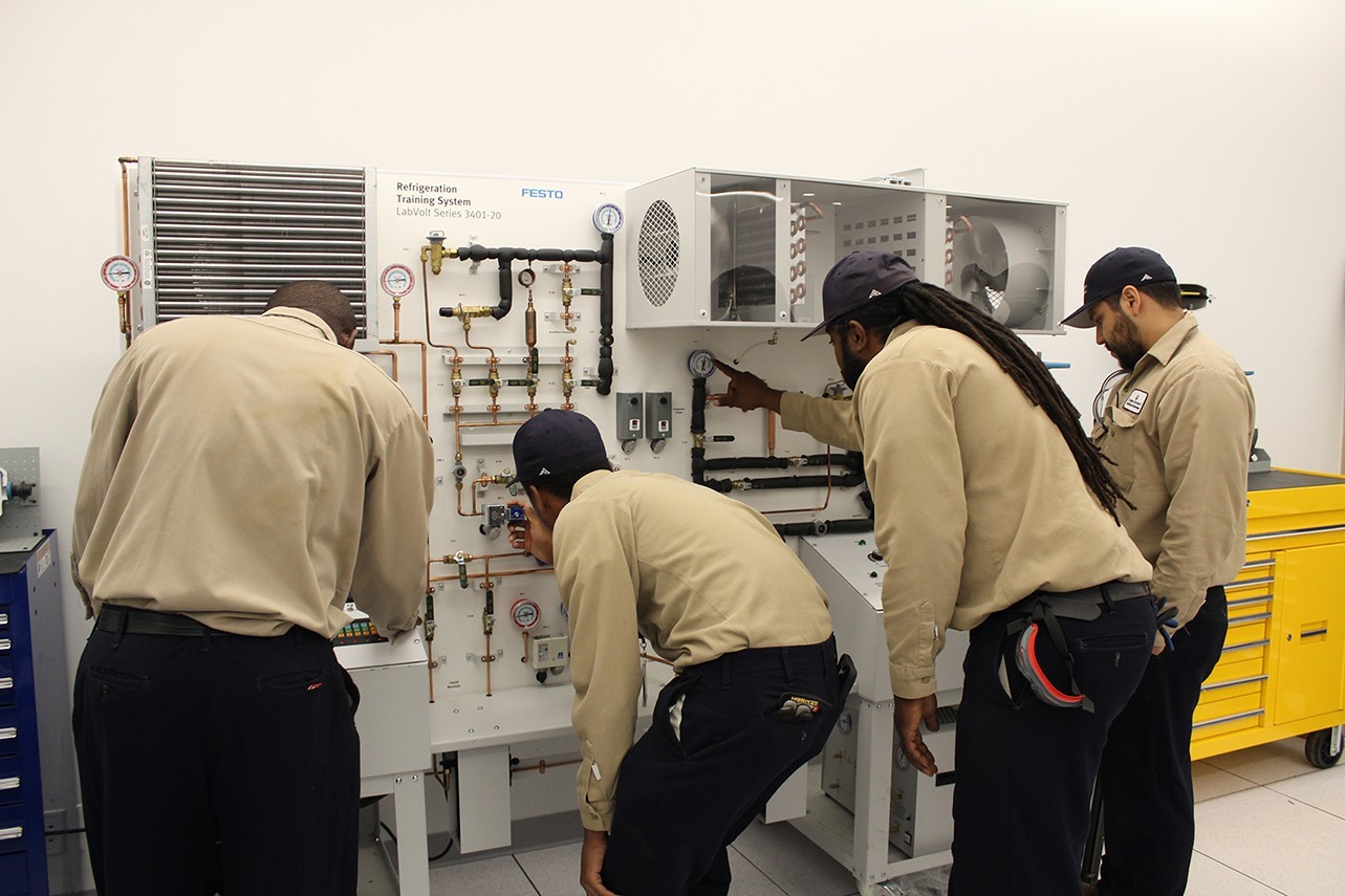 Apprentices (l to r) Evans Ampofo, Gary Hamilton, Keith DeFreitas, and Alphonso Espinoza receiving hands-on classroom training in the Studebaker Building at Columbia’s Manhattanville Campus.