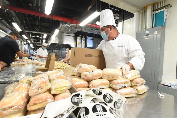 Columbia dining employees create meals in kitchen.