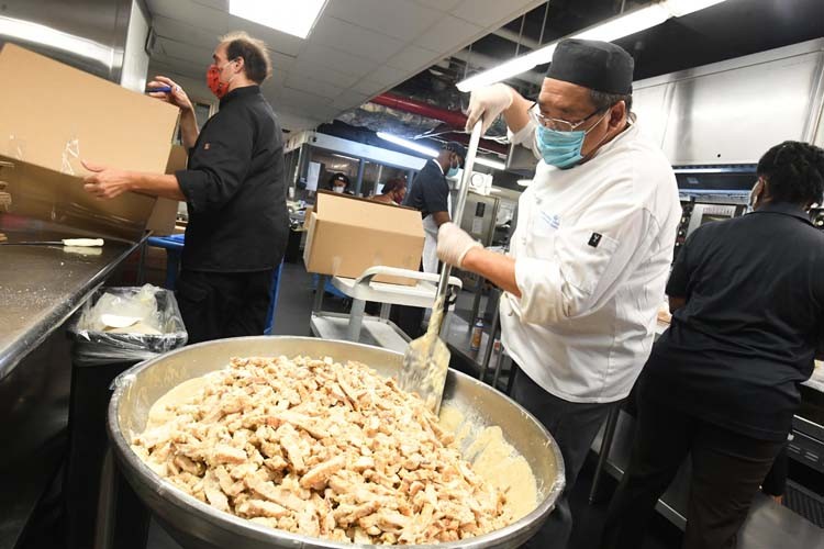 Columbia dining employees create meals in kitchen.