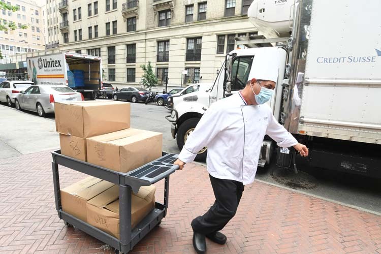 Columbia dining employees transport using hand cart.