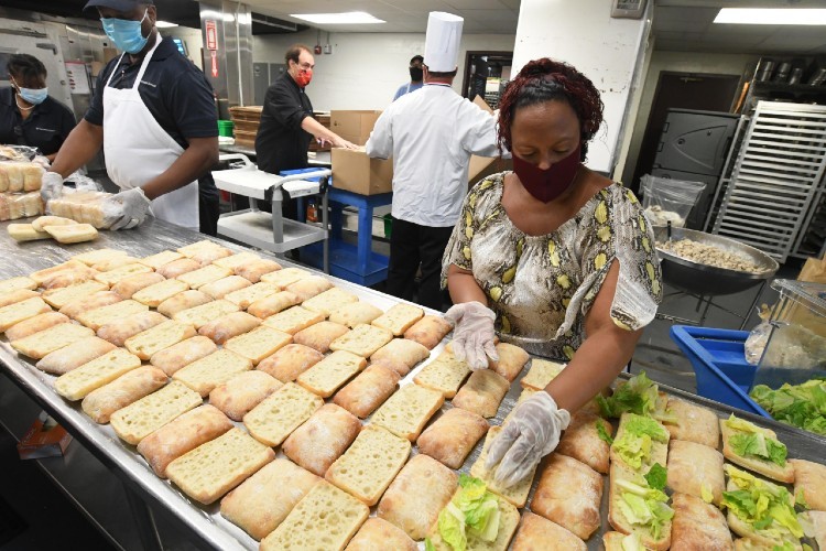 Columbia dining employees create meals in kitchen.