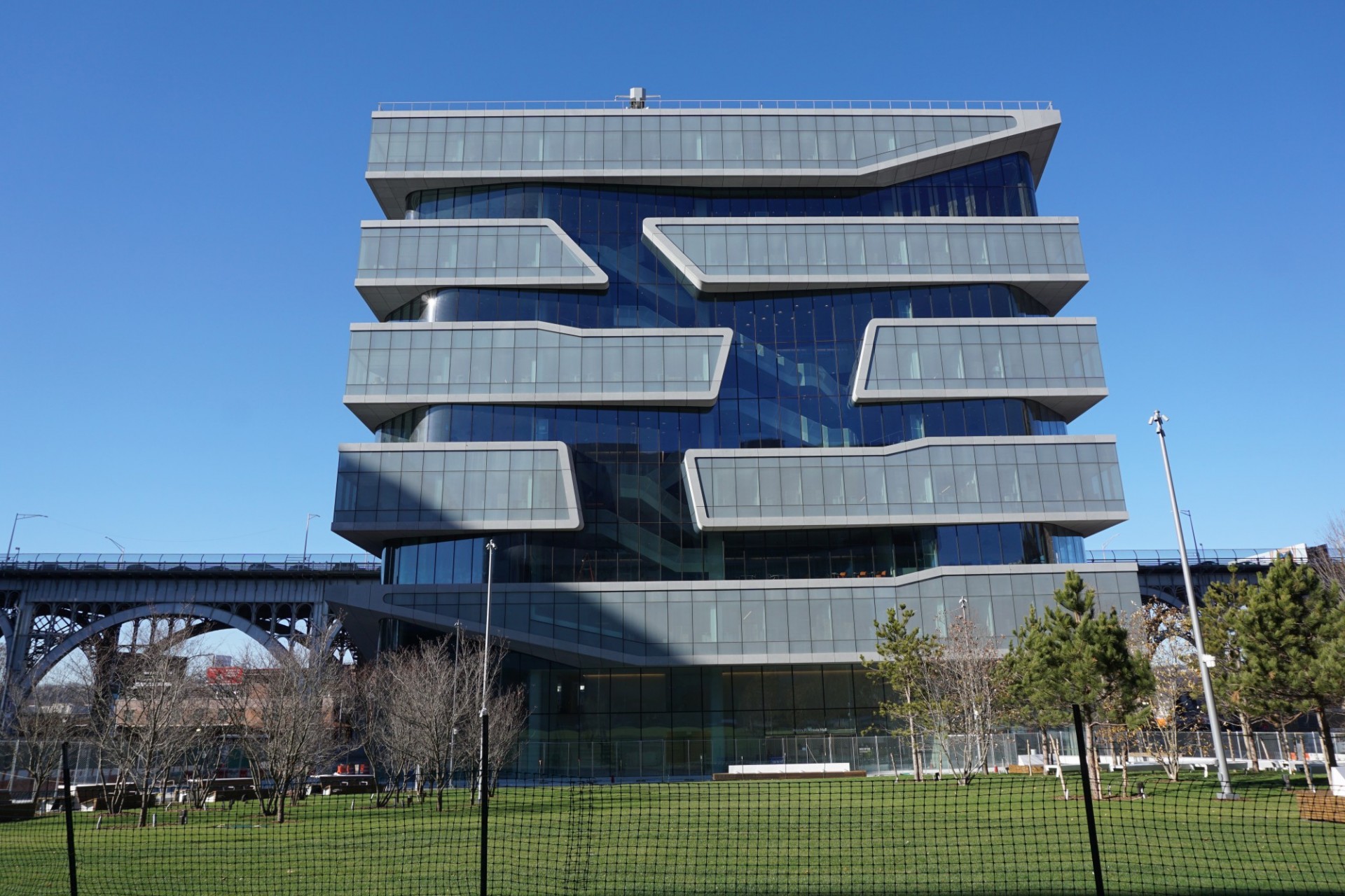 A newly constructed building with a clear glass and translucent glass facade.