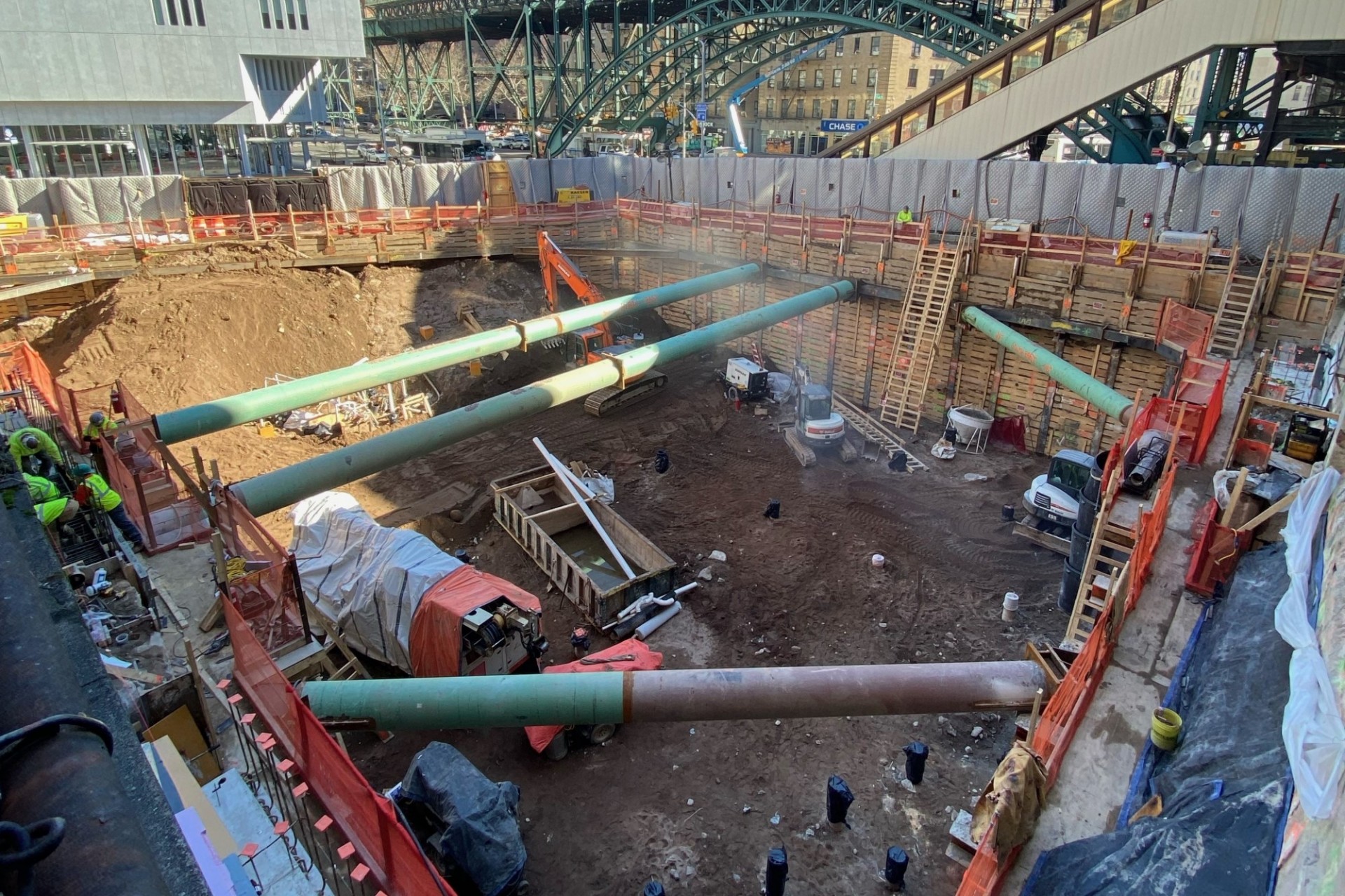 A view of the 600 W. 125th Street construction site with equipment and support pipes running across.   