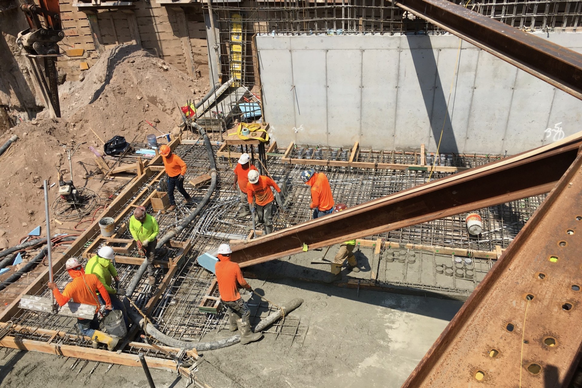 A view of the 600 W. 125th Street construction site with rebars along the perimeter of the northern portion of the site with steel beams overhead.