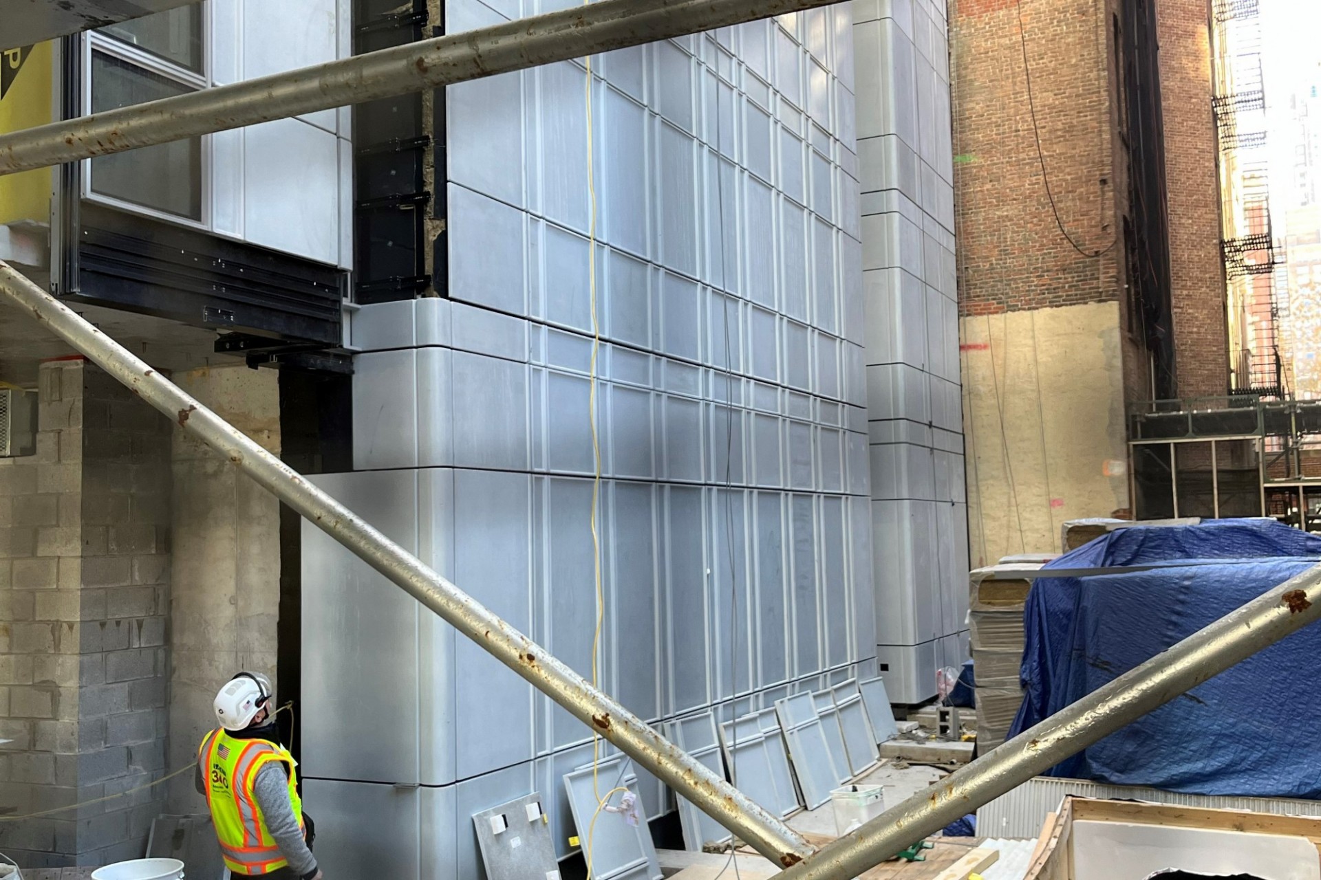 Gray curtainwall panels alongside the facade of 600 W. 125th Street.