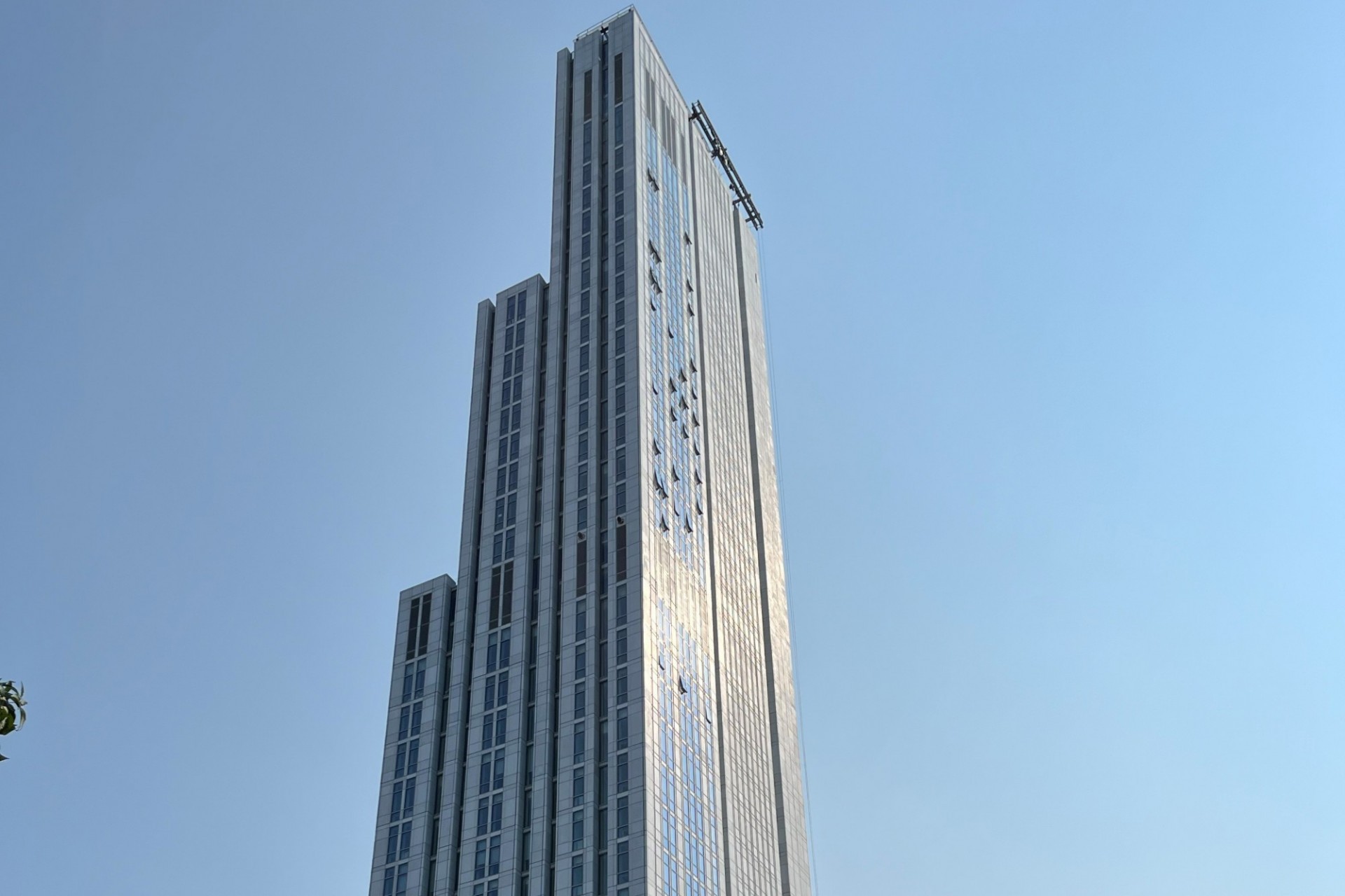 A view of the upper floors of 600 W. 125th Street, looking southeast, on a clear sky day.